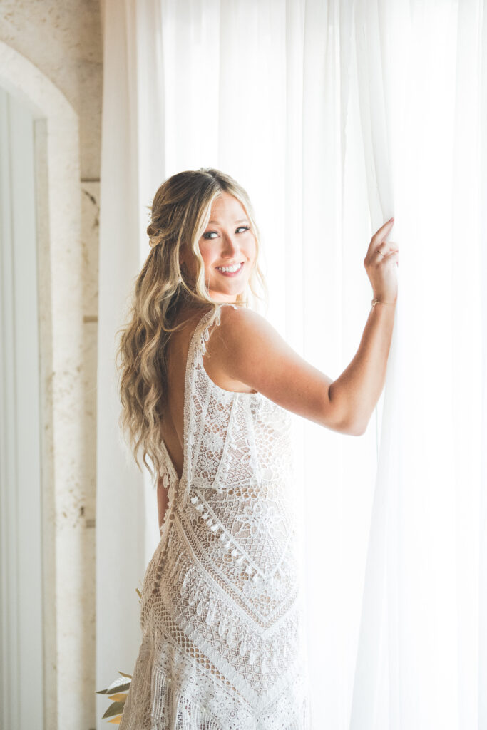 Bride standing in window